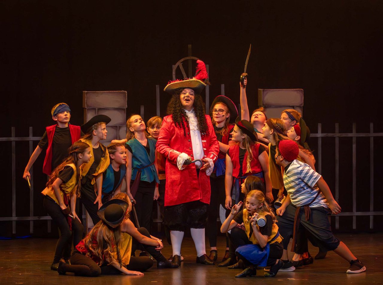 An Aspire performer leads the company in a Villains Night number