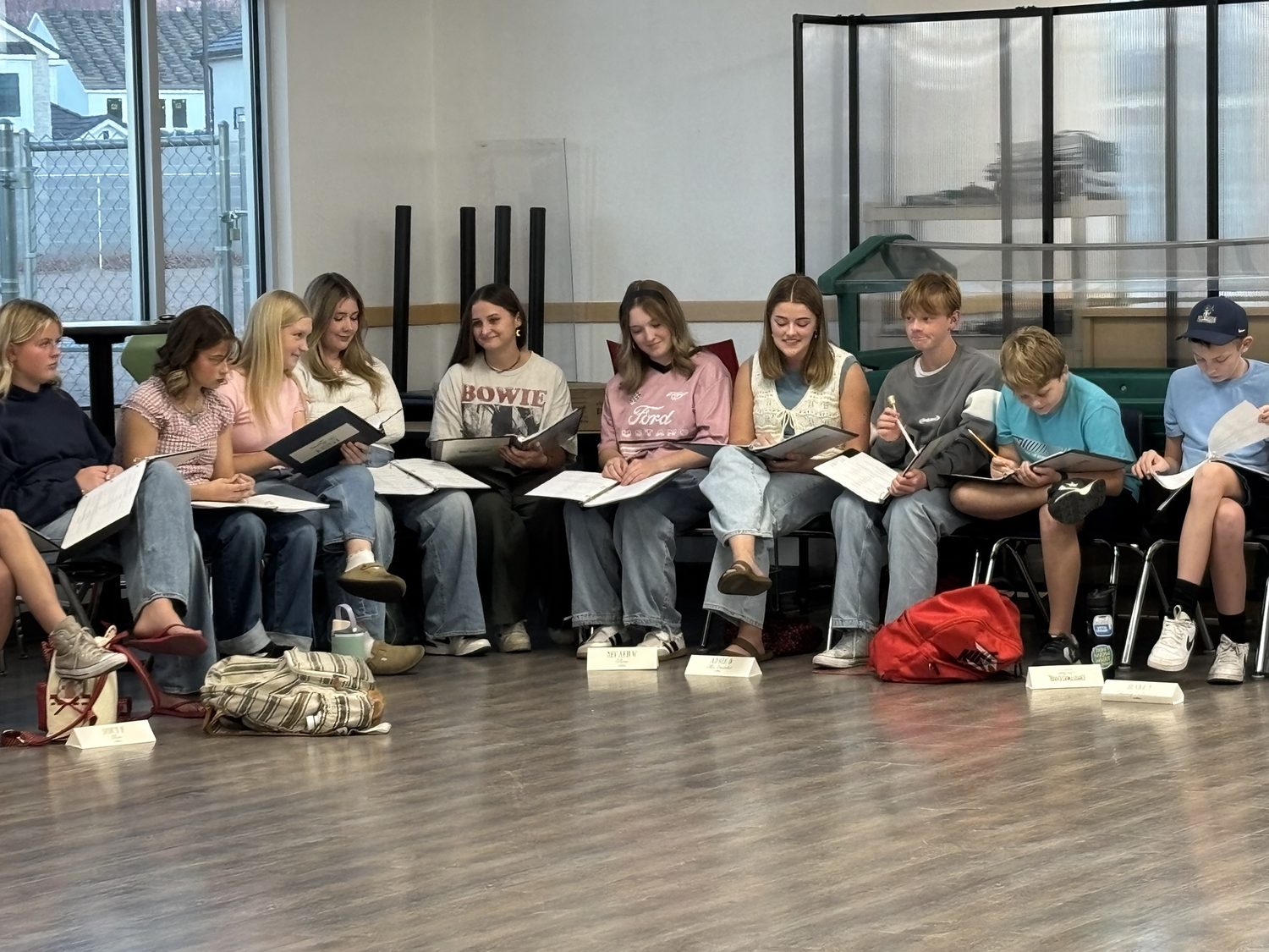 Encore Young Artists seated with scripts during a read-through of A Christmas Carol