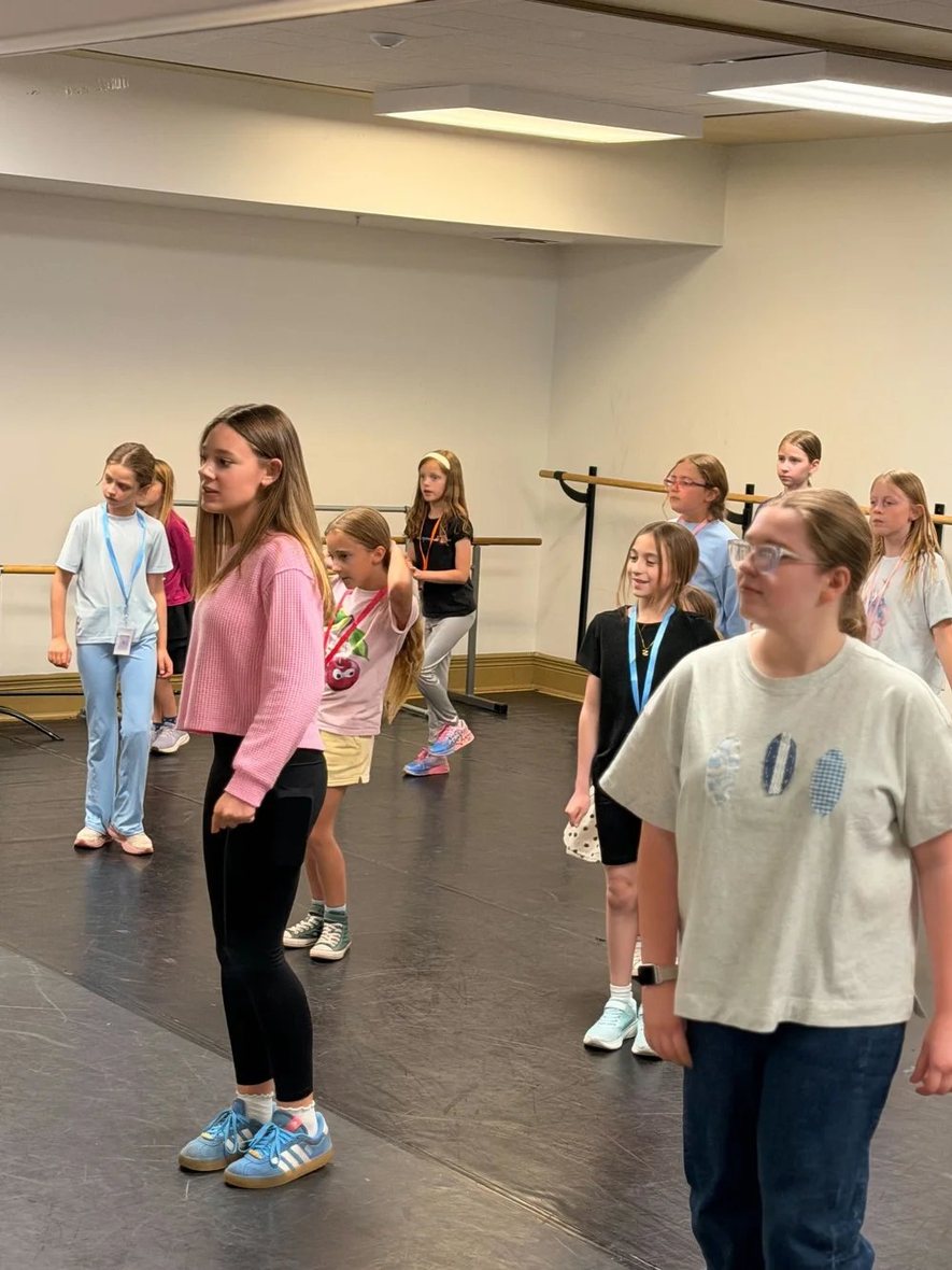 Young Artists lined up and rehearsing in the dance studio