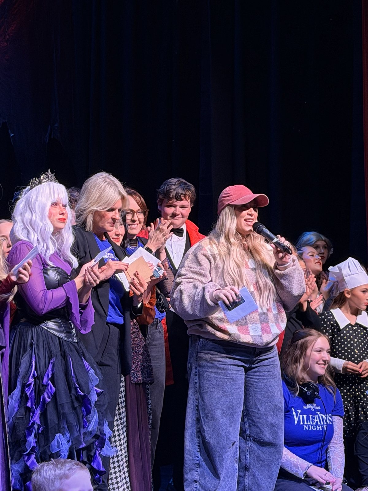 The Villains Night company gathered on stage in costume during the closing-night curtain call