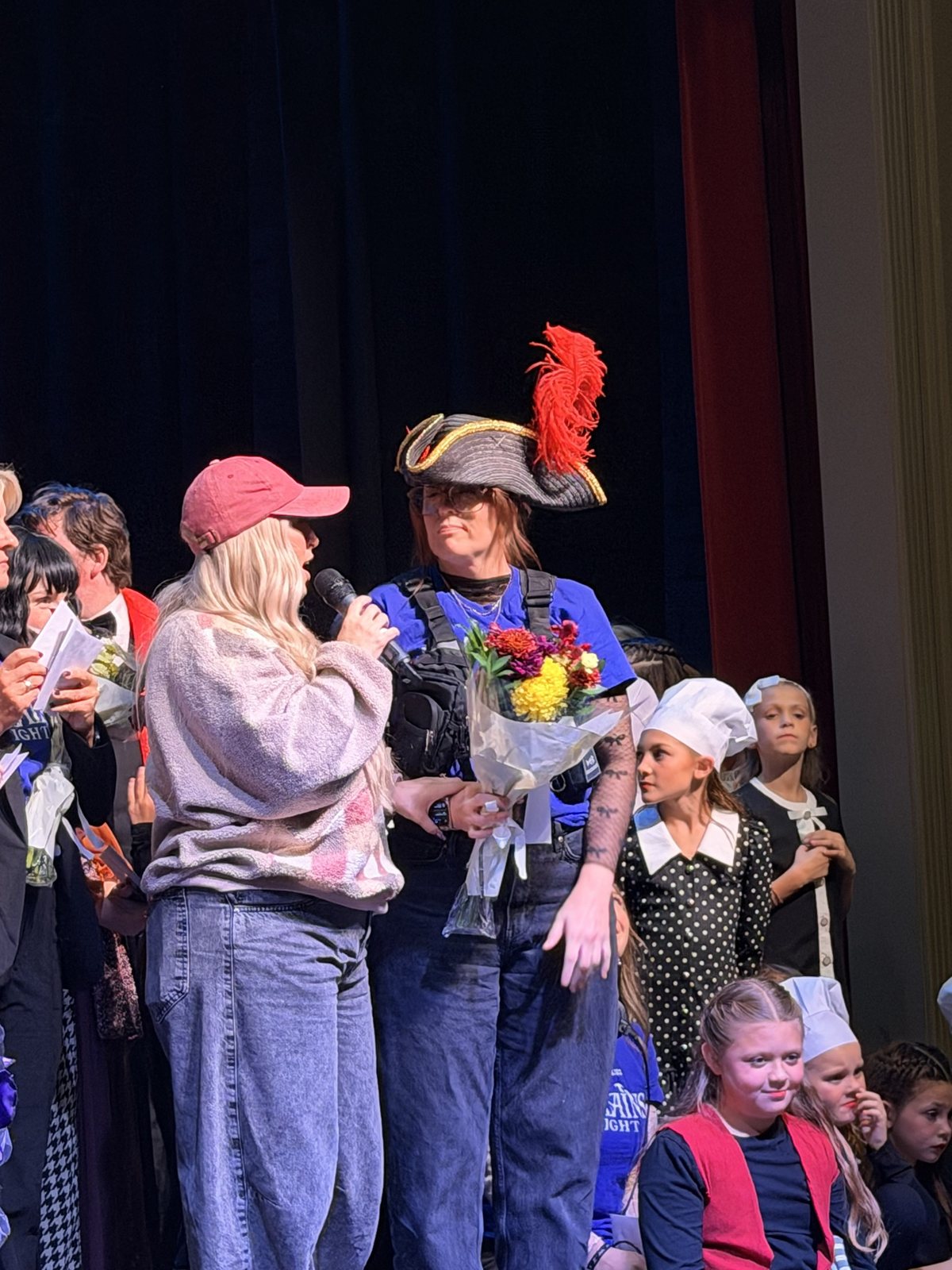 Flowers being presented to a member of the Villains Night production team on stage
