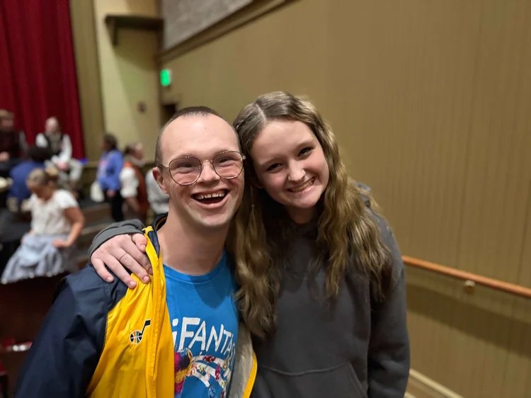 Two guests smiling together at an Encore performance