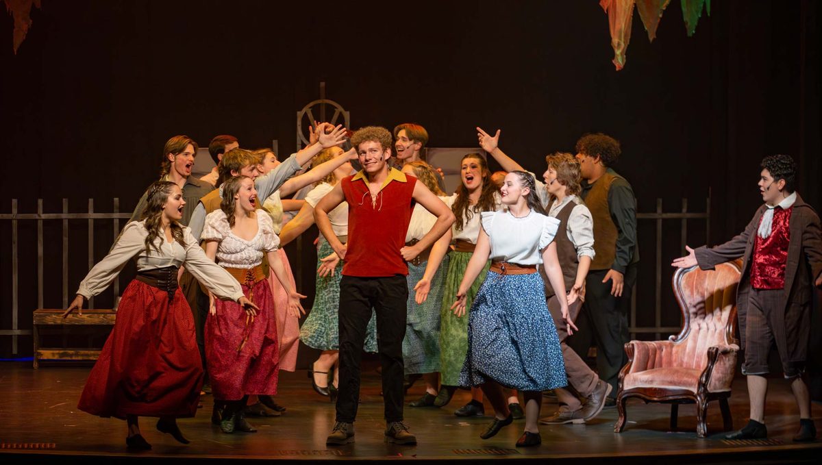 The Aspire Performing Co ensemble in period costume mid-number