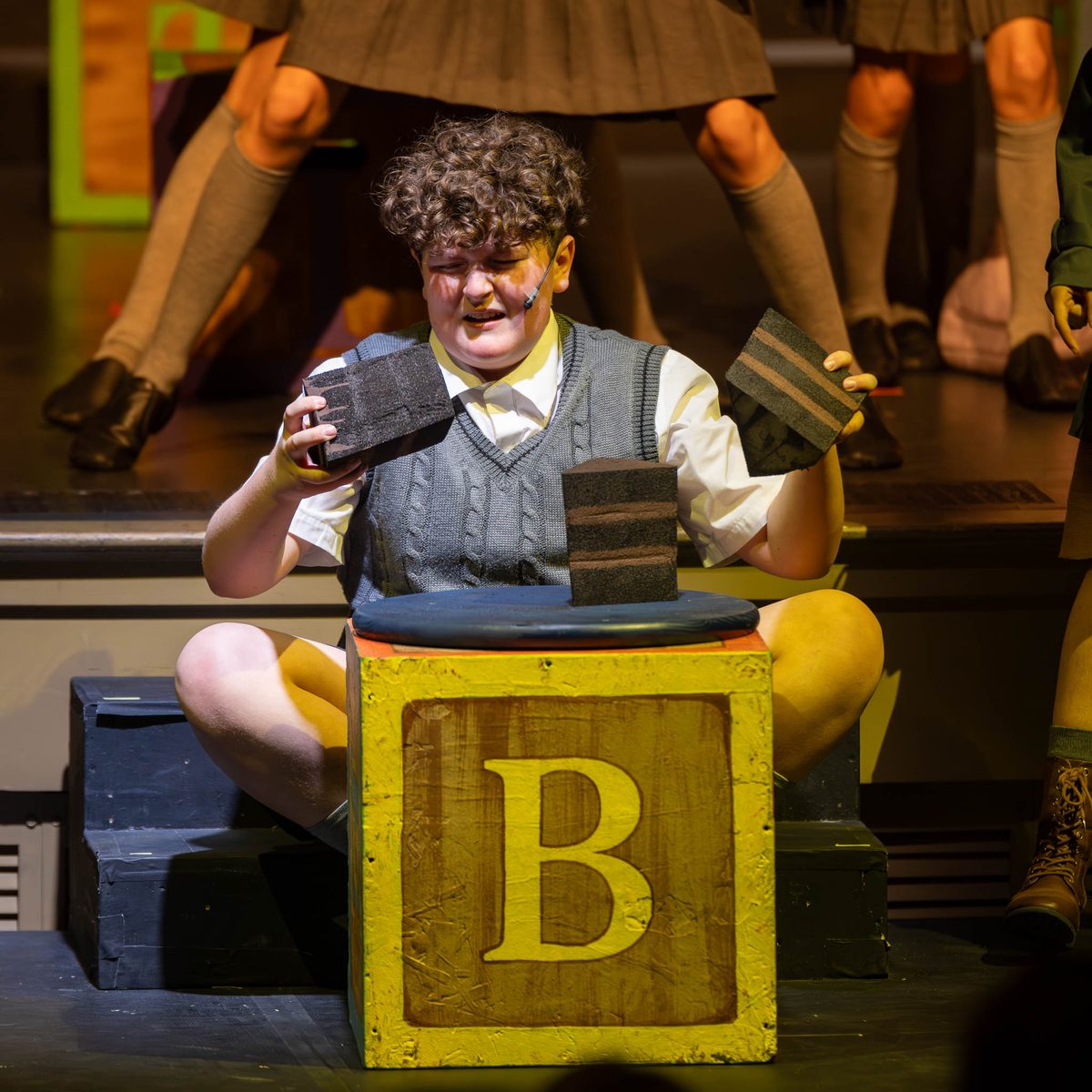 A young performer on a block letter in an Encore Emerging Artists production